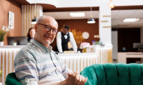 Metalworker wearing protective mask welding a custom mechanical part in a metallurgy workshop