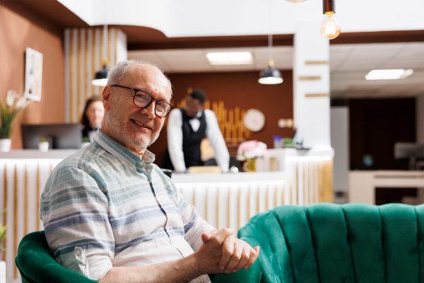 Metalworker wearing protective mask welding a custom mechanical part in a metallurgy workshop