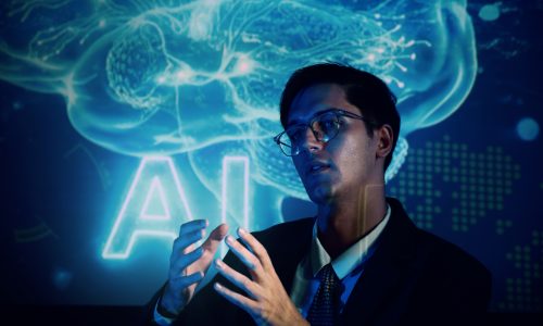 Metalworker wearing protective mask welding a custom mechanical part in a metallurgy workshop
